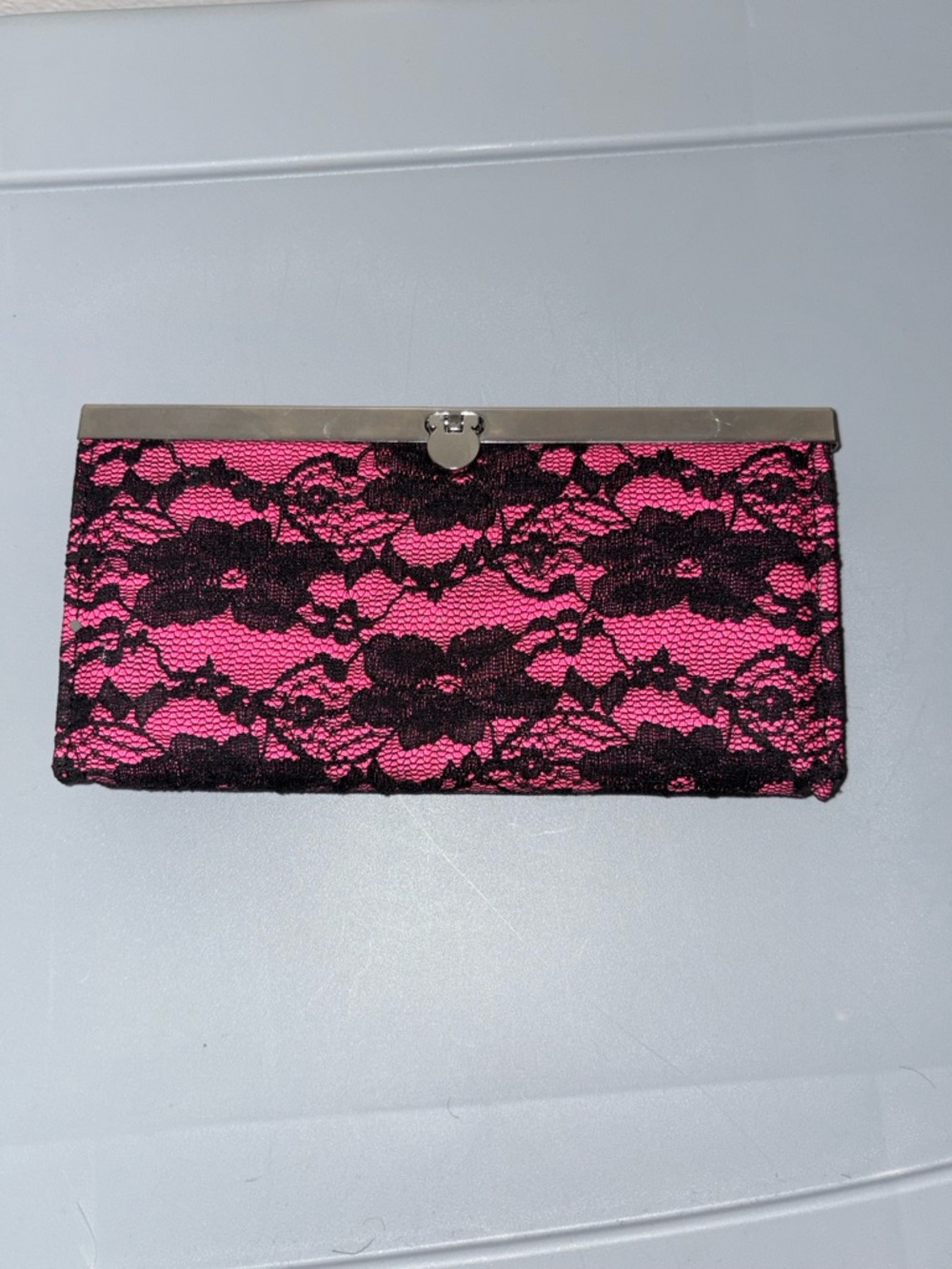 Amici Accessories Pink and black lace clutch with silver hardware